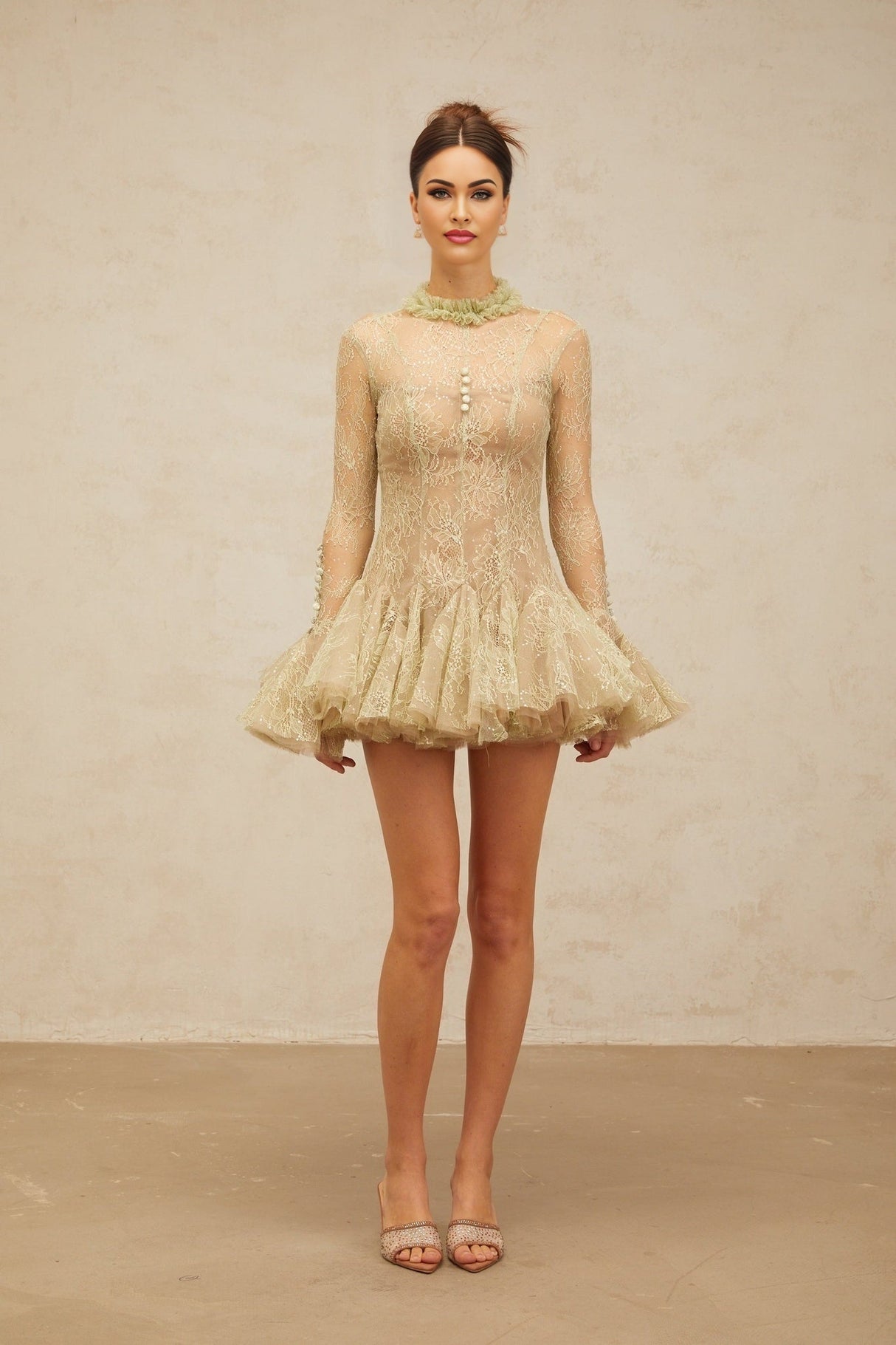 Young woman wearing a green mini dress with floral embroidery and flared skirt