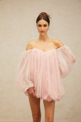 Young woman wearing a pink layered tulle mini dress with bubble skirt and sleeveless design