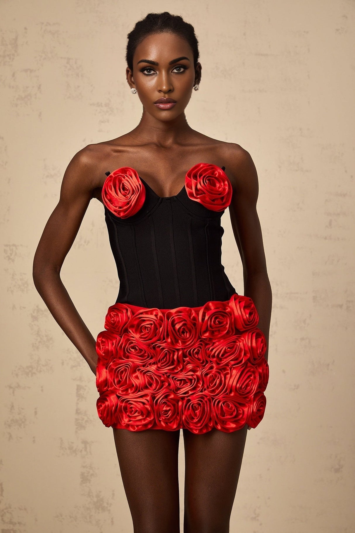 Young woman wearing a red matching set consisting of a top and skirt with rose applique details