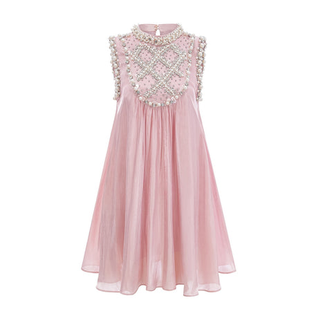 Young woman wearing a short pink dress with pleated skirt and embellished bodice