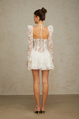 Young woman wearing a white mini dress with floral lace pattern and corset style bodice